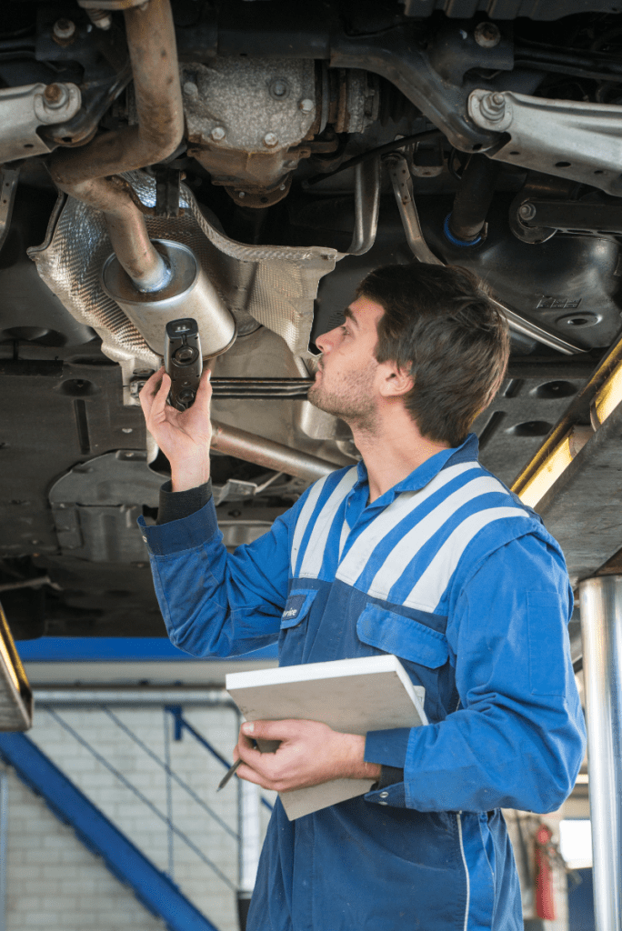 Mechanic inspecting a vehicle - MOT Testing in Mollinsburn